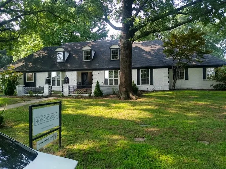 White painted brick ranch home with black shutters and front door, painted by David Woodall Painting