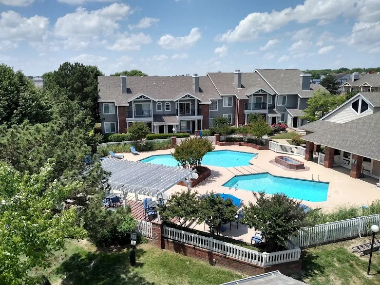 Apartment complex exterior with pool, painted in gray and white